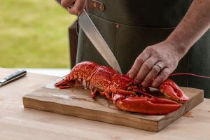 lobster being prepped on a chopping board