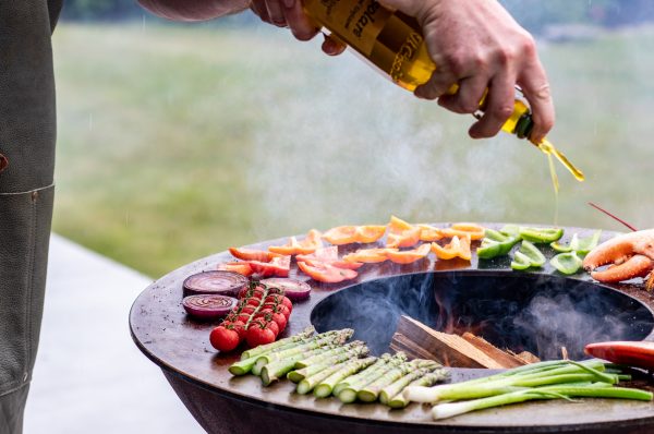 outdoor cooking on a plancha with vegetables