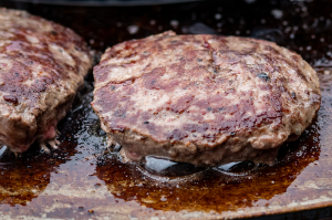 A Christmas burger cooking on a Quoco Plancha